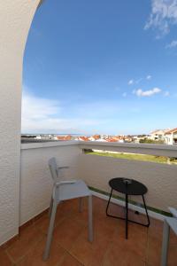 a balcony with a table and chairs and a view at Hotel Mediteran in Zadar