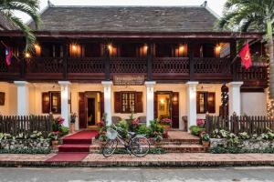 a house with a bike parked in front of it at Mekong Riverview Hotel in Luang Prabang