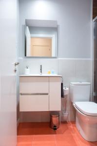 a bathroom with a white sink and a toilet at Hotel Fira Boutique Barcelona in Hospitalet de Llobregat +33 photos