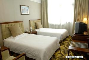 Postel nebo postele na pokoji v ubytování Xiyuan Hotel