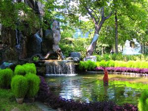 a fountain with a fire hydrant in a garden at Xiyuan Hotel in Beijing