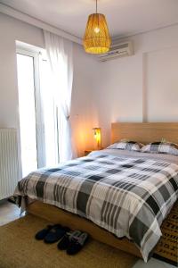 a bedroom with a bed and a window and shoes at Boutique52 Luxury Apartments in Athens