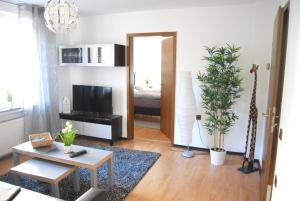 a living room with a television and a mirror at Apartment Unna-Massen in Unna