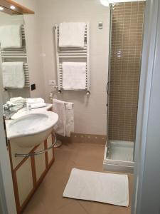 y baño con lavabo y ducha. en apartment Zagara - Gardone Riviera center en Gardone Riviera