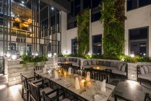 a restaurant with tables and couches in a building at Kantary Hotel Korat in Nakhon Ratchasima