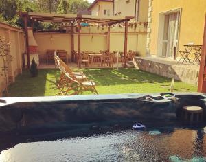 a bath tub in the yard of a house at Da Vinci Guesthouse in Varshets