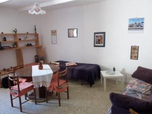 a living room with a table and a couch at Enjoy Badolato! in Badolato +24 photos
