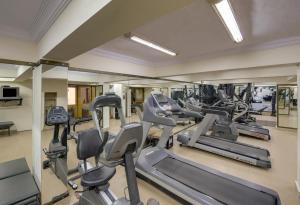 a gym with treadmills and elliptical machines at Pride Hotel Pune in Pune