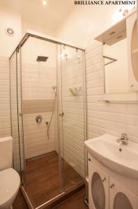 a shower in a bathroom with a toilet and a sink at Presidency House Self Check-in Apartments in Sofia +55 photos