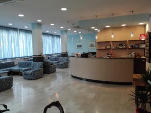 a lobby with chairs and a bar in a hospital at Hotel Senio in Riolo Terme