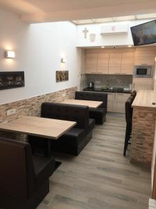 a restaurant with tables and chairs and a kitchen at Sobe-Rooms Kvatric in Zagreb