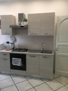 a kitchen with a sink and a stove at Luxurious Street Apartments in Catania