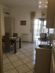 a kitchen with a table and a stove top oven at Luxurious Street Apartments in Catania