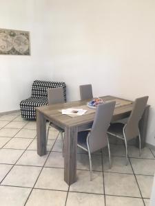 a wooden table and chairs in a room at Luxurious Street Apartments in Catania