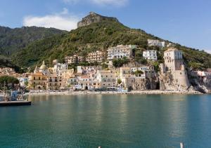a group of buildings on a hill next to the water at Affittacamere Nonno Ninì in Cetara