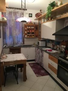 a small kitchen with a table and a tableablish at La Stellina in Castenaso