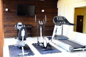 a gym with two tread machines and a tv at Hotel Do Forte in Macapá