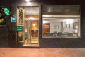 a store front with a window with chairs in it at Hotel Brisa in A Coruña