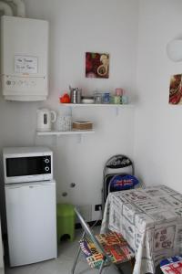 a kitchen with a table and a microwave and a refrigerator at "la Luna" in Vernazza