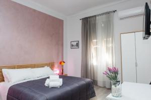 a bedroom with a bed and a window at Foresteria Boccadasse in Genoa