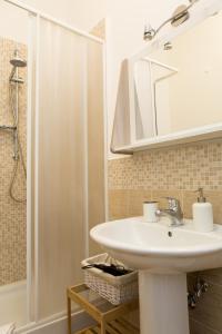 a bathroom with a sink and a shower with a mirror at Foresteria Boccadasse in Genoa