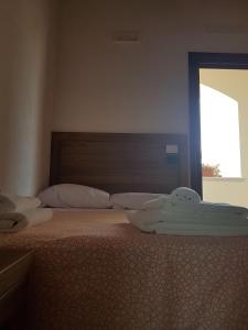 Postel nebo postele na pokoji v ubytování Agriturismo L'Ulivo