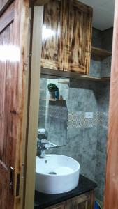 a bathroom with a white sink and a counter at The Treehouse A @ Trees Residences in Manila