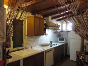 a kitchen with a sink and a counter top at Cottage in the green in Misterbianco +14 photos