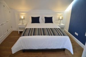 a bedroom with a large bed with two night stands at Edificio Charles 303 in Funchal