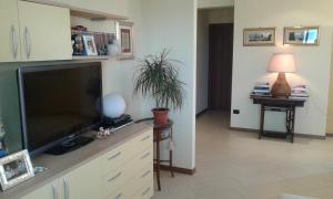 a living room with a flat screen television on a counter at Bed and Breakfast San Valentino in Terni