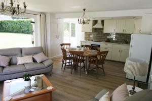a living room with a couch and a table and a kitchen at Gite at 105 in Nampont-Saint-Martin