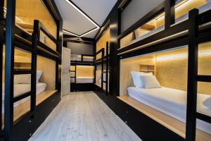 a room with two bunk beds in it at GiG Capsule Hostel in Ericeira