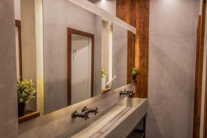 a bathroom with a sink and a mirror at GiG Capsule Hostel in Ericeira