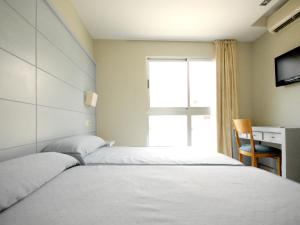 Postel nebo postele na pokoji v ubytování Hotel Safari