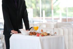 a man standing next to a table with a plate of food at Finca Prats Hotel Golf & Spa in Lleida