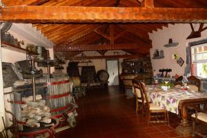 a dining room with a table and chairs in a house at Quinta Nossa Senhora de Lourdes in Capelas