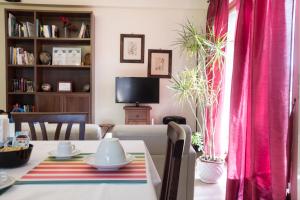 a living room with a table and a pink curtain at Il Mulino in Guardiagrele