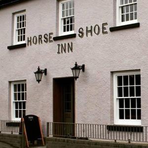 a white building with the words horse shoe inn at The Horseshoe Inn in Crickhowell