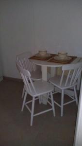 a table and chairs with bowls and plates on it at Studio in Copa in Rio de Janeiro