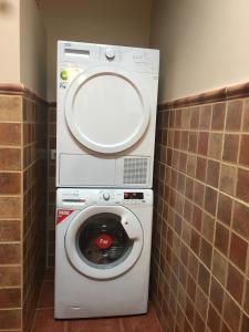 a washing machine with a mirror on top of it at Villa Rafael in Vega de San Mateo