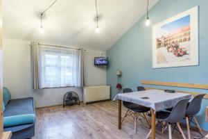 a living room with a table and chairs at Apartamenty Amber in Krakow