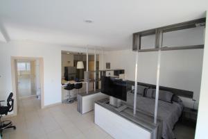 a living room with a bed and a flat screen tv at Boutique Apartment Downtown 1506 in Mexico City +8 photos