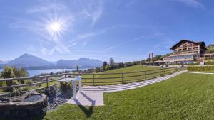 a house on a hill with a view of a lake at Hotel Restaurant Panorama in Aeschlen