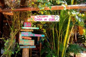 a street sign with many different signs on it at Casa del Sol in Montañita