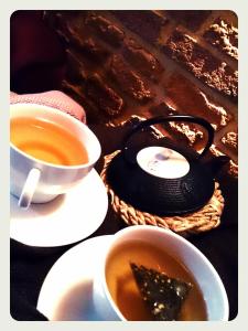 a table with two cups of tea and a tea pot at Les Ecuries de la Tour in Mondonville