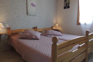 1 dormitorio con 2 camas y 2 lámparas en Gîte Les Sauvasses, en Puy-Sanières
