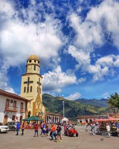 a group of people walking in front of a clock tower at Elizabetha Hostal in Salento