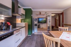 a kitchen with a table and a dining room at Appartements Rieser - im Herzen von Mayrhofen - sonniger Balkon - 3 Schlafzimmer in Mayrhofen