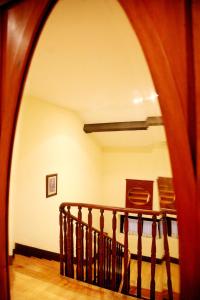 an archway leading to a staircase in a house at Hotel Casa de Indianos Don Tomás in Nueva de Llanes