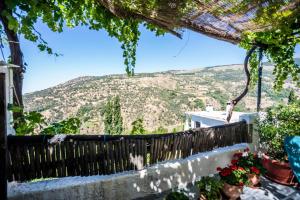 a view from the balcony of a house with a mountain at Casa el Portón in Bubión